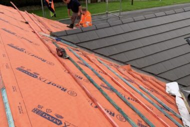 A roof being worked on by professional roofers